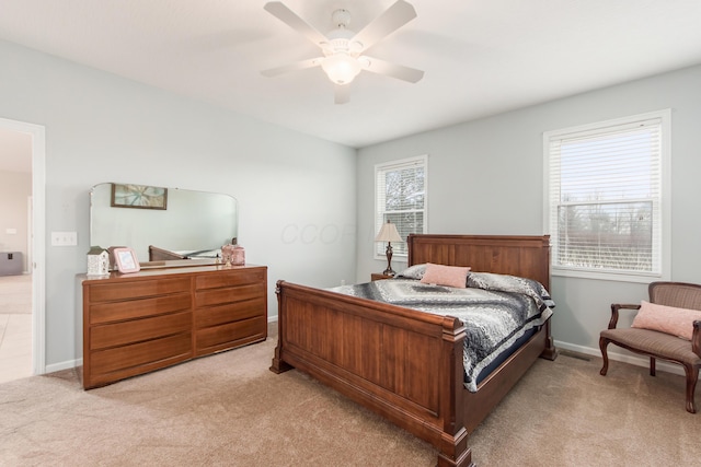 bedroom with light carpet, ceiling fan, and baseboards