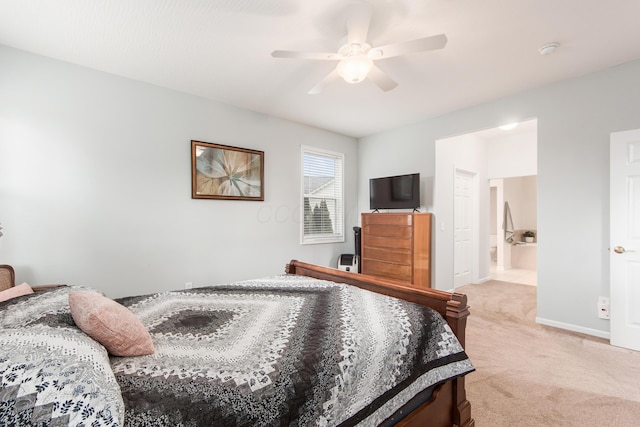 bedroom with ensuite bath, baseboards, a ceiling fan, and light colored carpet