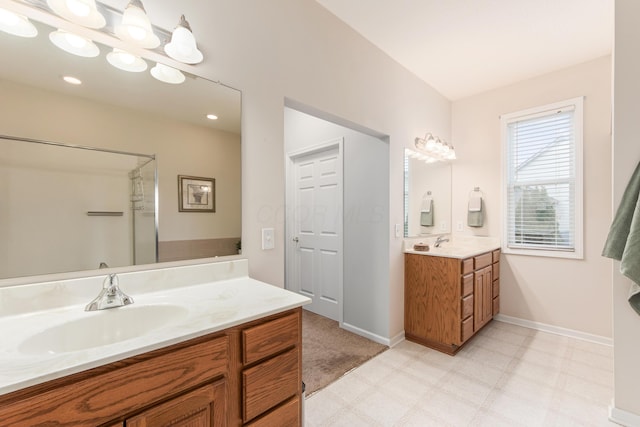 bathroom with two vanities, a sink, baseboards, and tile patterned floors