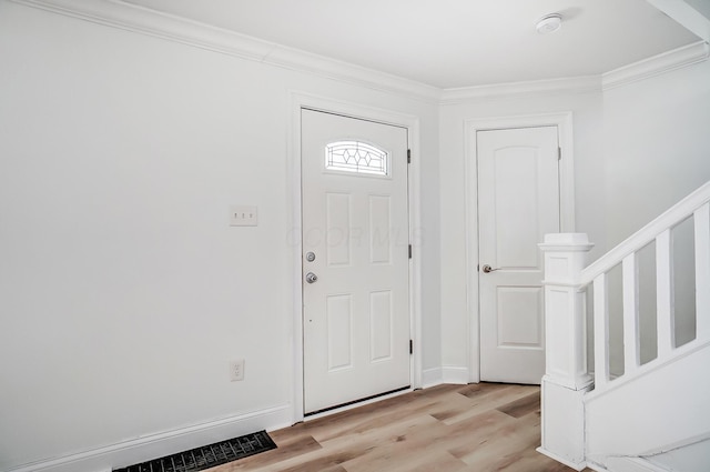 entrance foyer with light hardwood / wood-style flooring and ornamental molding