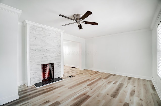 unfurnished living room with a fireplace, ornamental molding, light wood-type flooring, and ceiling fan