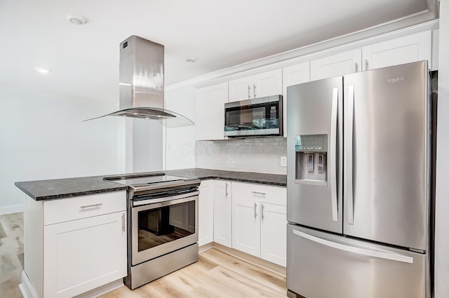 kitchen with white cabinetry, stainless steel appliances, light hardwood / wood-style floors, dark stone countertops, and island exhaust hood