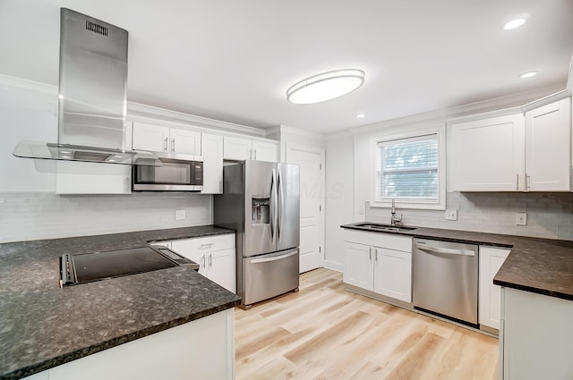 kitchen featuring appliances with stainless steel finishes, sink, white cabinetry, island range hood, and light hardwood / wood-style floors