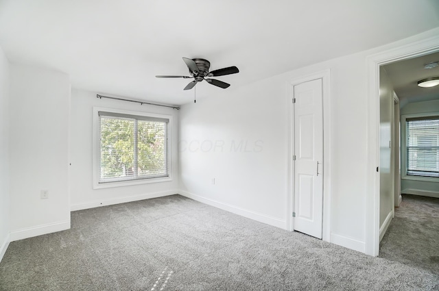 carpeted empty room featuring ceiling fan