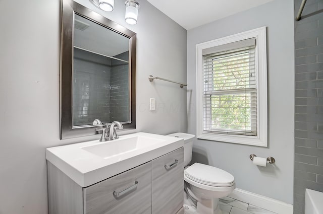 bathroom with toilet, vanity, and a shower