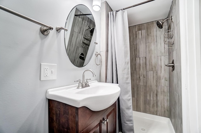 bathroom featuring vanity and a shower with shower curtain