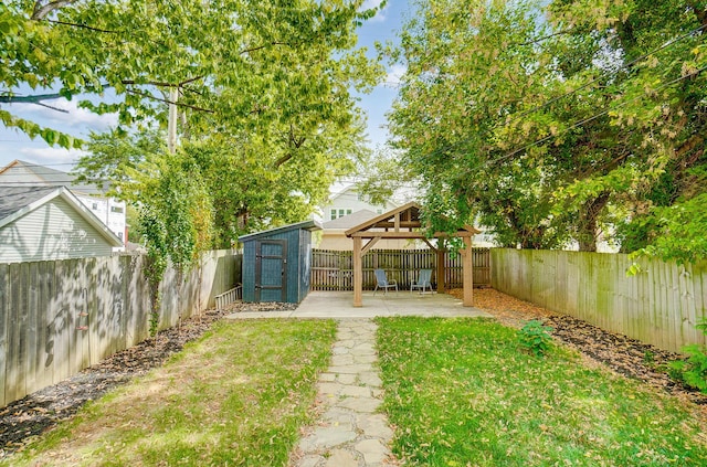 view of yard with a storage unit, a patio, and a gazebo