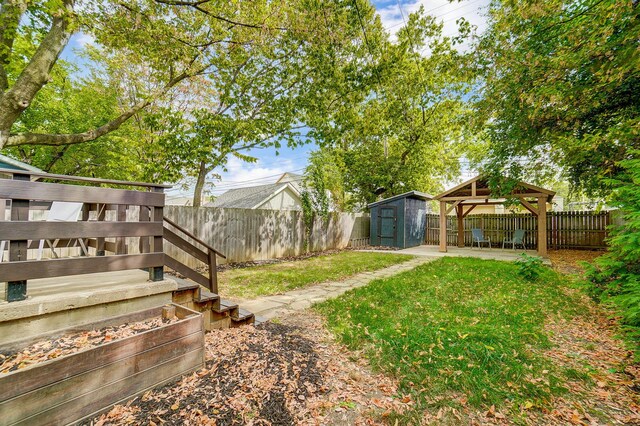 view of yard with a gazebo and a storage shed