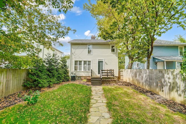 rear view of property with a yard