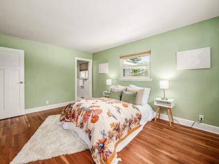 bedroom featuring baseboards and wood finished floors