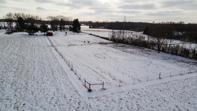 yard layered in snow with a rural view