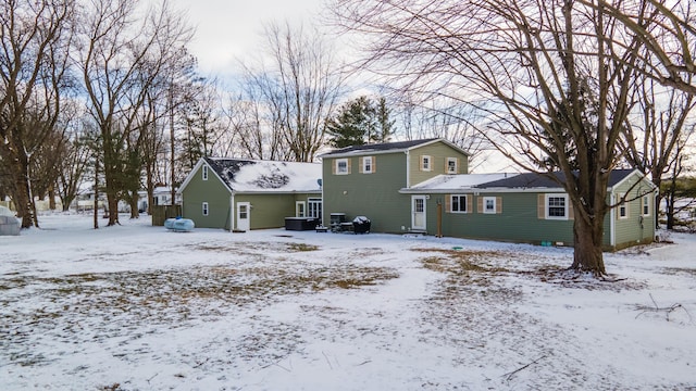 view of snow covered rear of property