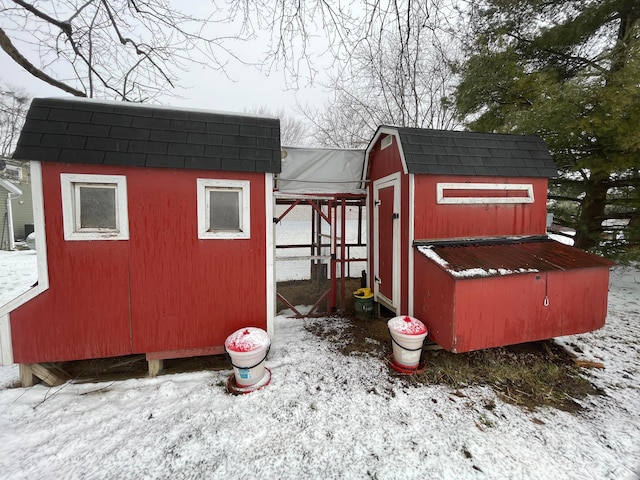 snow covered structure with an outdoor structure and exterior structure