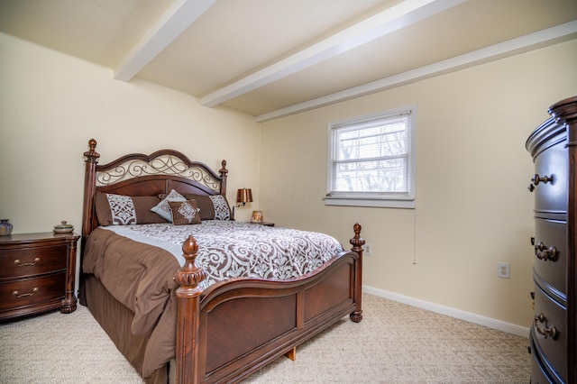 bedroom featuring light colored carpet, beam ceiling, and baseboards