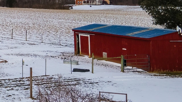 exterior space featuring fence, an outbuilding, and an outdoor structure