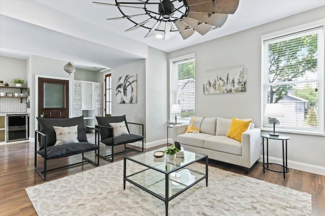 living room featuring ceiling fan, dark wood-type flooring, and beverage cooler