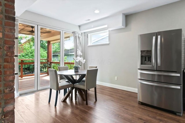 dining space with dark hardwood / wood-style flooring