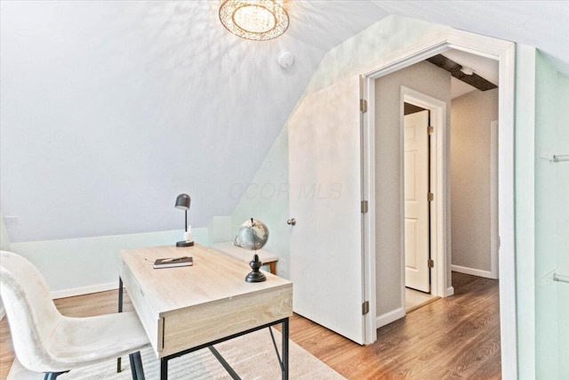 office space with vaulted ceiling and wood-type flooring