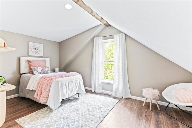 bedroom featuring dark hardwood / wood-style floors and lofted ceiling with beams