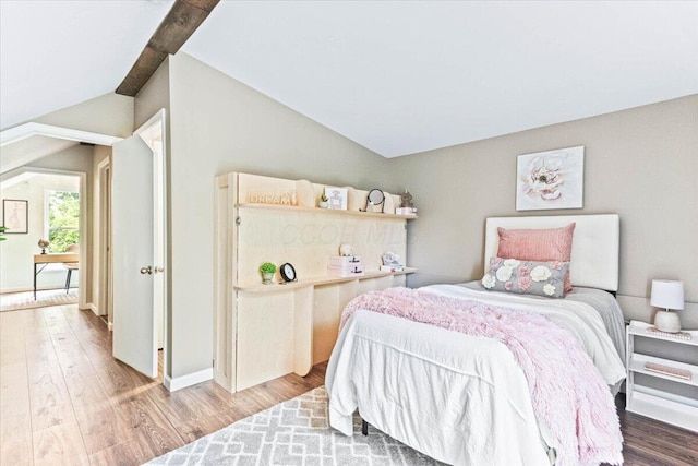 bedroom featuring lofted ceiling and hardwood / wood-style floors