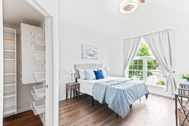 bedroom with vaulted ceiling and wood-type flooring