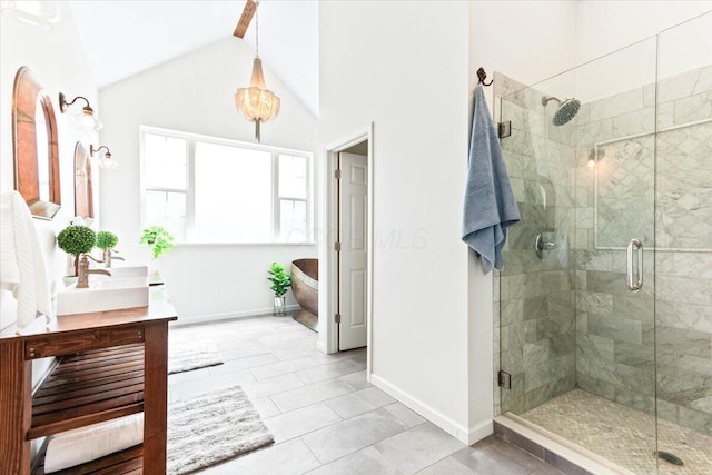 bathroom with lofted ceiling, tile patterned flooring, an enclosed shower, and vanity