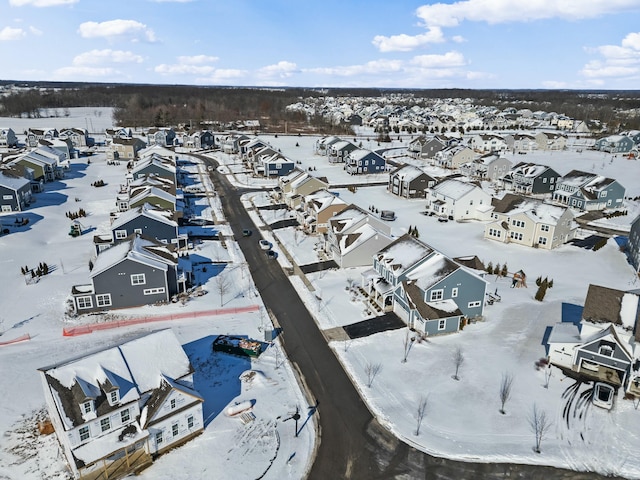 snowy aerial view featuring a residential view