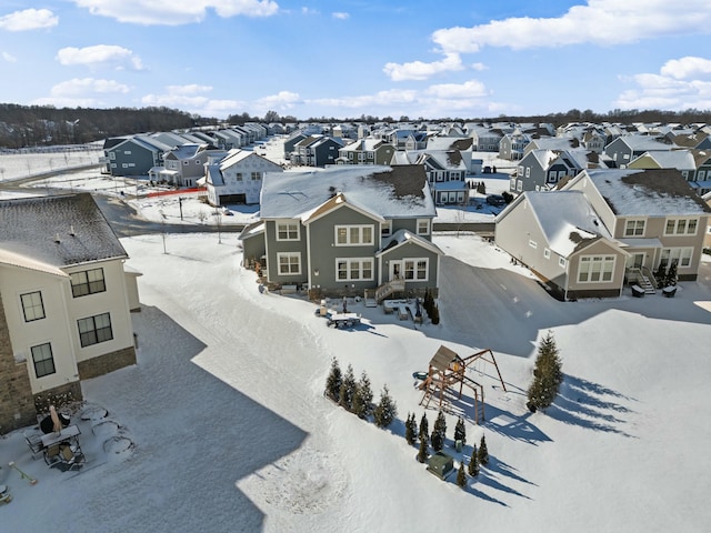 snowy aerial view featuring a residential view