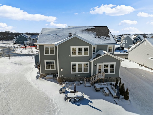 snow covered property featuring a residential view