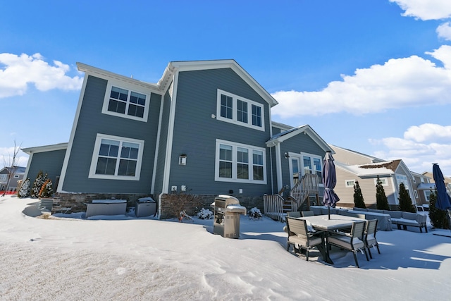 view of snow covered back of property