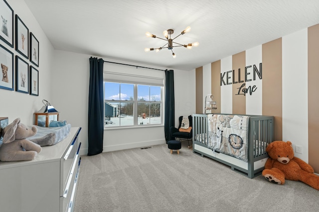 bedroom featuring visible vents, light carpet, a textured ceiling, a chandelier, and baseboards