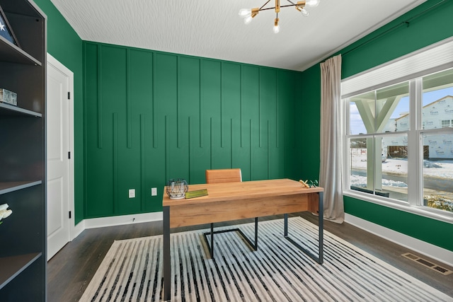 office space with baseboards, dark wood-style flooring, visible vents, and an inviting chandelier