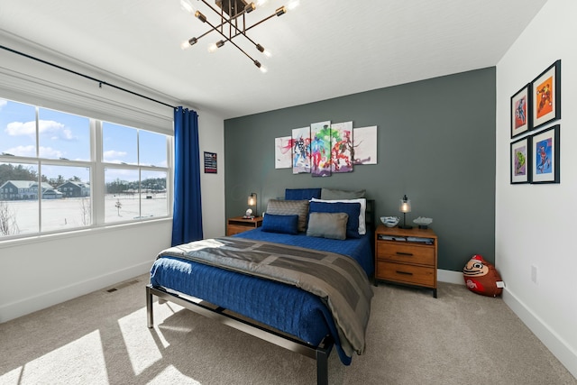 bedroom featuring a chandelier, carpet floors, visible vents, and baseboards