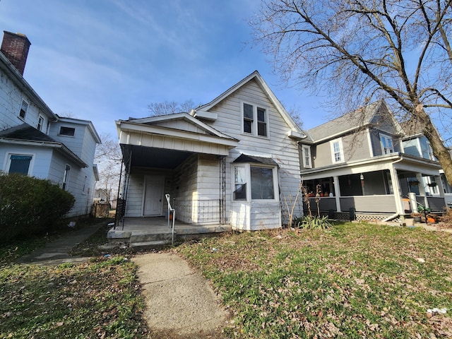 front of property featuring covered porch and a front lawn