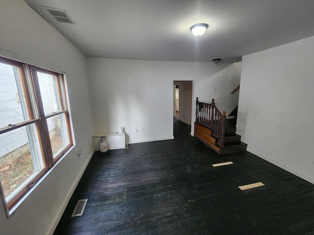 unfurnished room with dark hardwood / wood-style floors