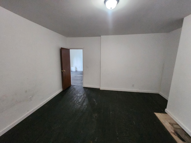 spare room featuring dark hardwood / wood-style floors