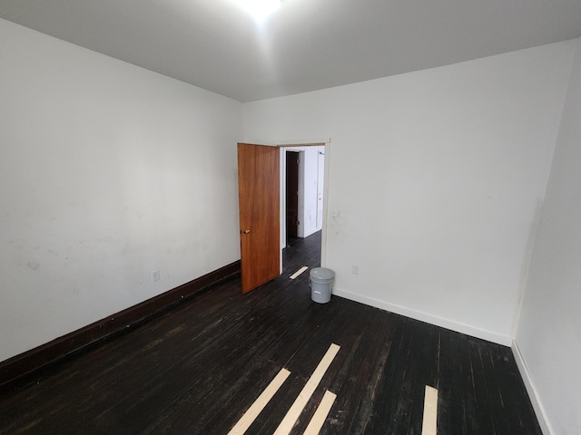 spare room featuring dark hardwood / wood-style flooring