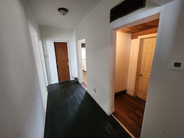 corridor with dark hardwood / wood-style floors