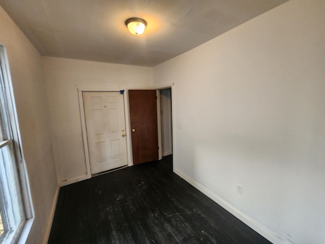 empty room featuring dark wood-type flooring