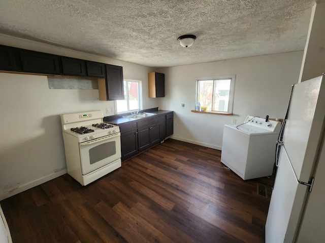 kitchen featuring sink, white appliances, dark hardwood / wood-style floors, and a textured ceiling