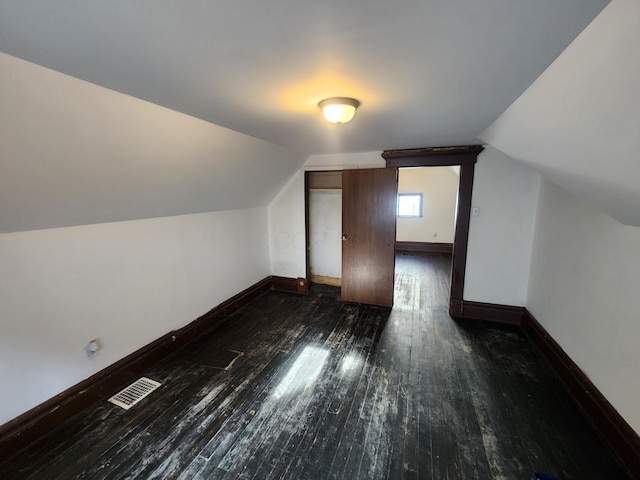 bonus room featuring vaulted ceiling and dark hardwood / wood-style flooring