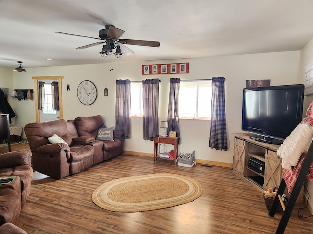 living room featuring ceiling fan, a wealth of natural light, and hardwood / wood-style floors