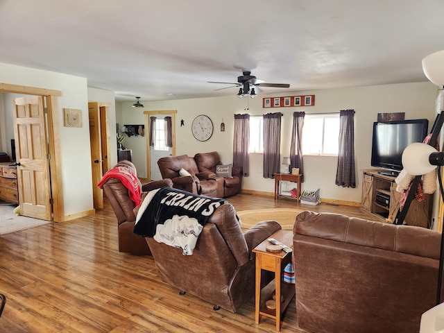 living room with hardwood / wood-style floors and ceiling fan