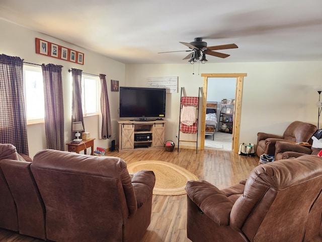 living room featuring ceiling fan and hardwood / wood-style floors