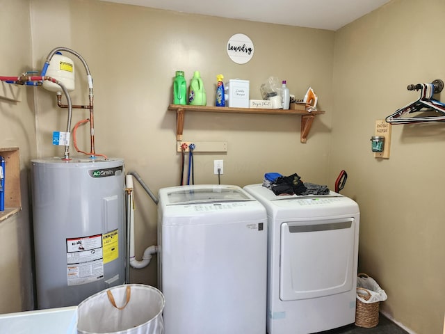 clothes washing area with washer and dryer and electric water heater