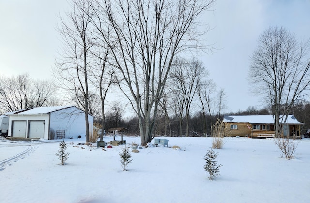 yard layered in snow with a garage