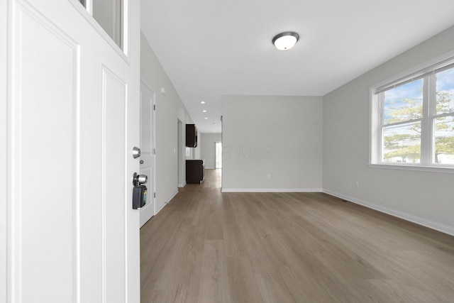 interior space with recessed lighting, light wood-type flooring, and baseboards