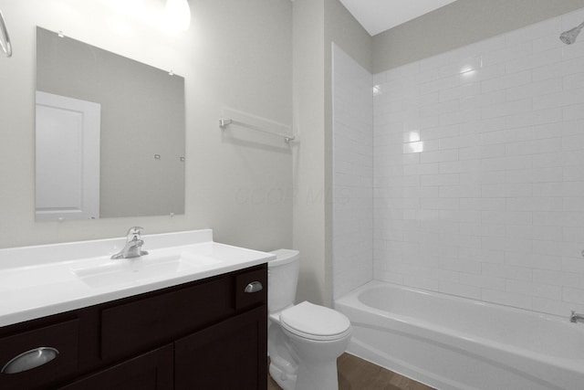 bathroom featuring shower / bathtub combination, vanity, toilet, and wood finished floors