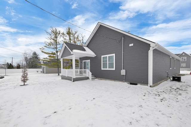 view of snow covered rear of property