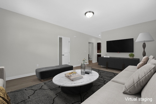 living area featuring baseboards and wood finished floors